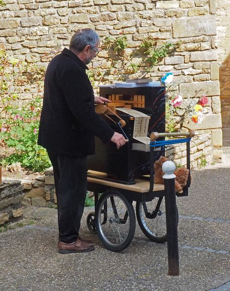 A man playing a crank organ